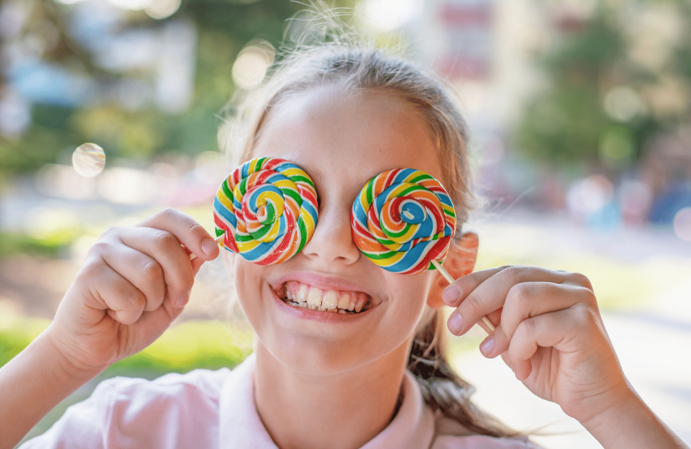 girl smiling lollipops