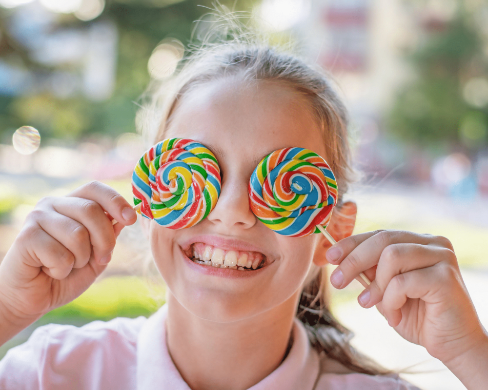 girl smiling lollipops