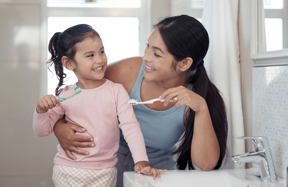 mom and daughter brushing teeth mom and daughter brushing teeth