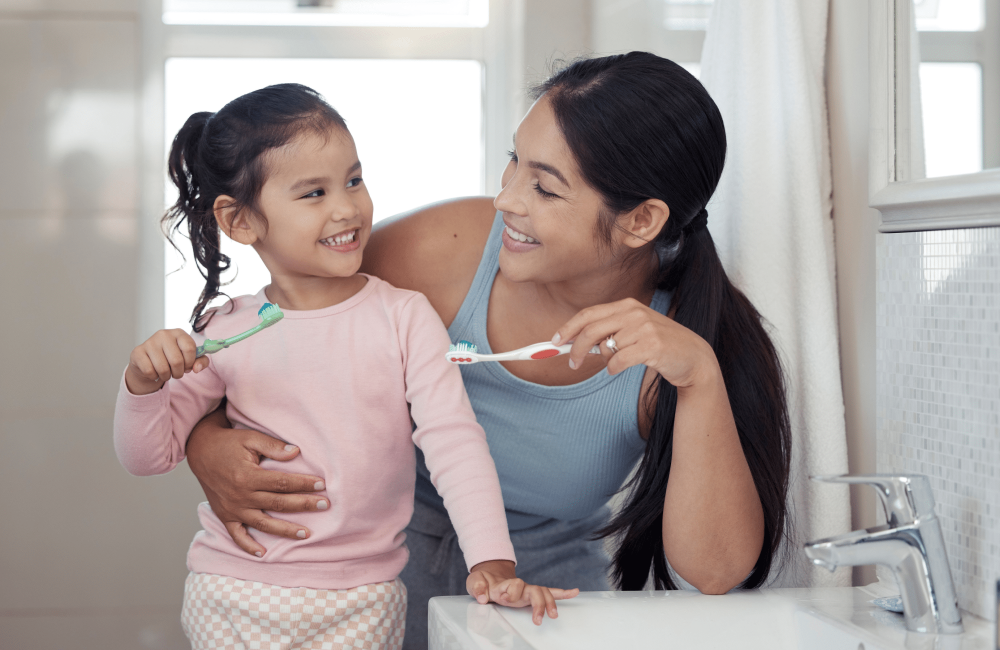 mom and daughter brushing teeth