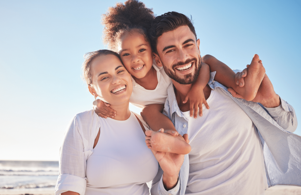 parents and kid on beach