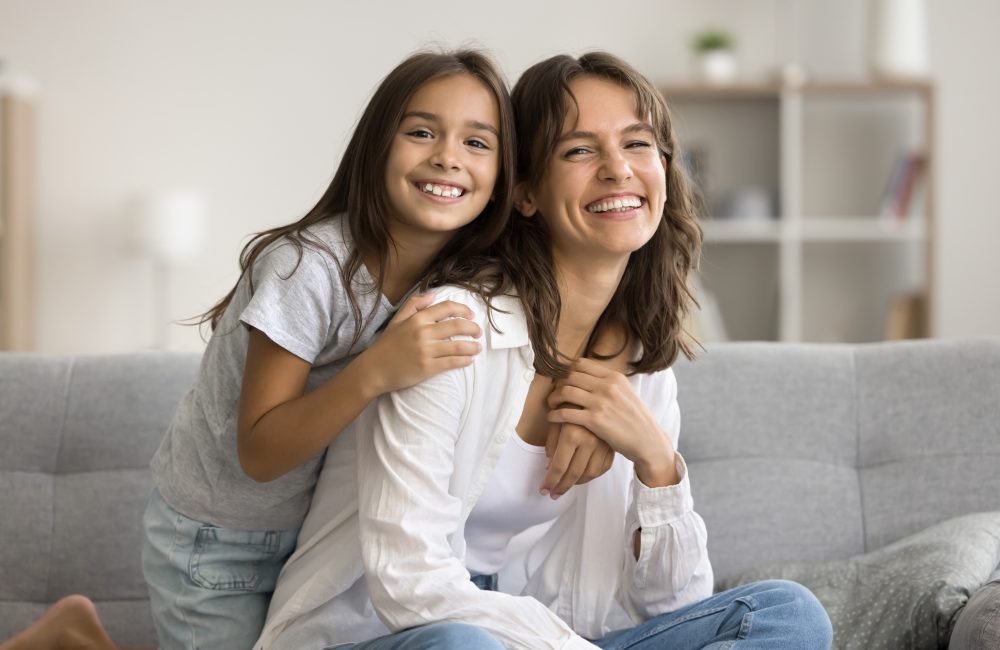 Lovely,Preschooler,Daughter,Embracing,Her,Young,Mommy,,Sitting,Together,On